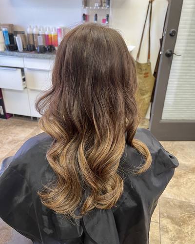 Finished K-tip extensions from the back: long, soft brunette-to-blonde waves